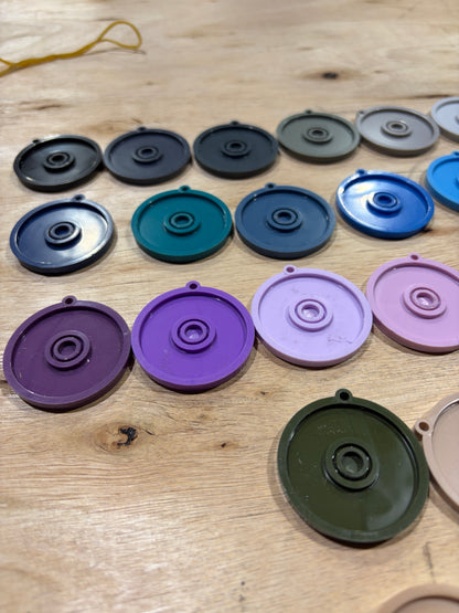 Close up of the grey, blue and purple PLA+ swatch discs
